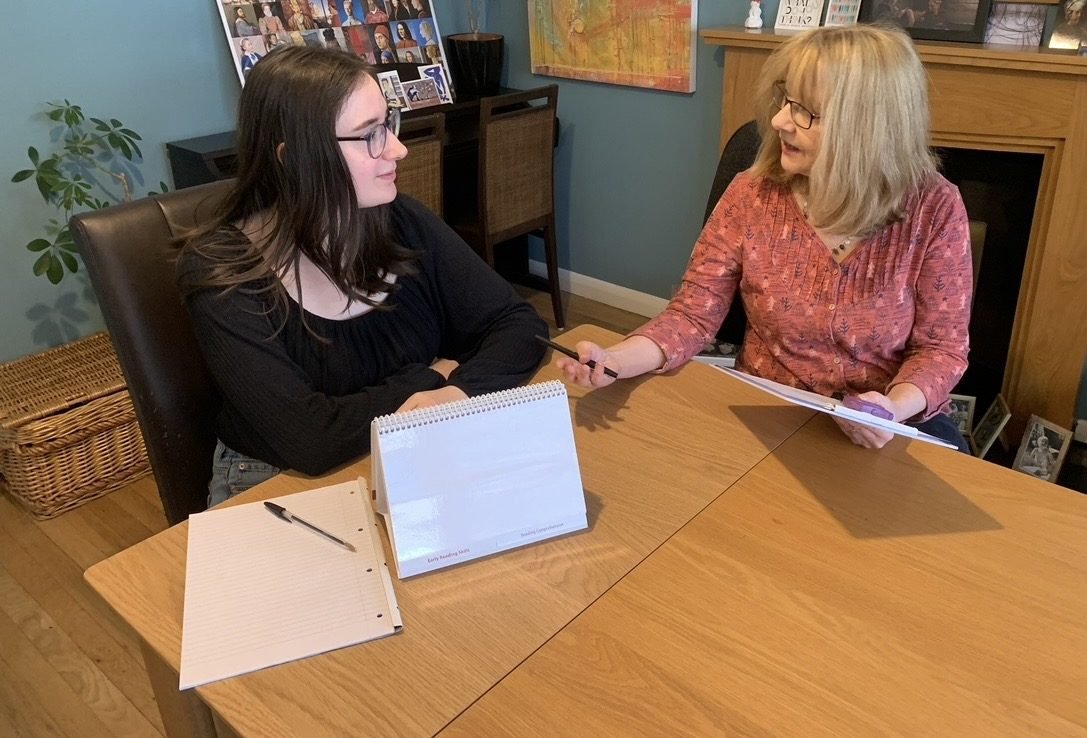 Christine working with a young woman at the assessment table