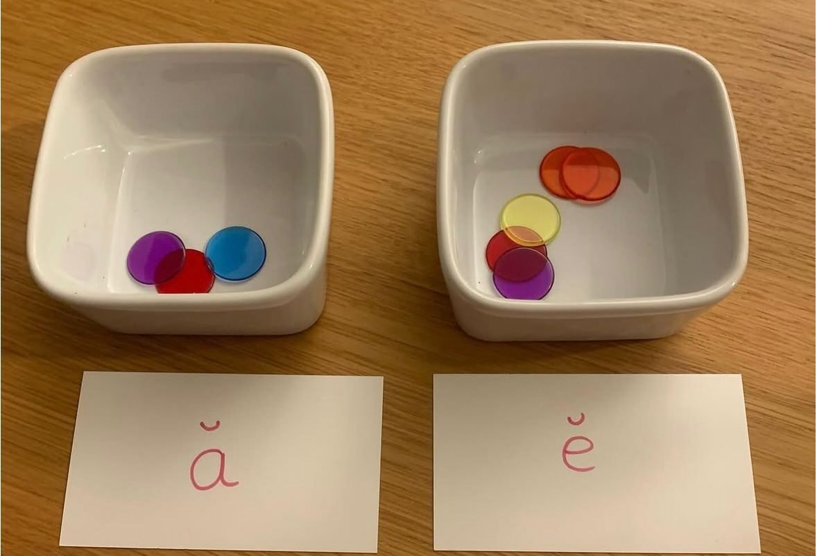 Small dishes of coloured counters, used in word and sound games